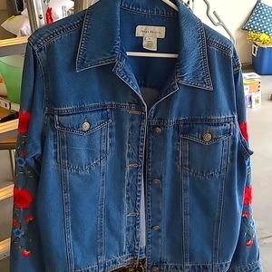 Women's jean jacket with flower embroidery on sleeves, size medium.